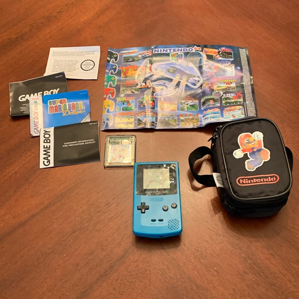 Authentic super Mario brothers game boy color deluxe in a teal blue color.